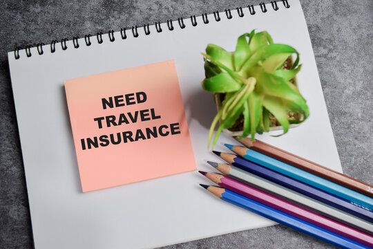 Concept of need travel insurance write on sticky notes isolated on Wooden Table.