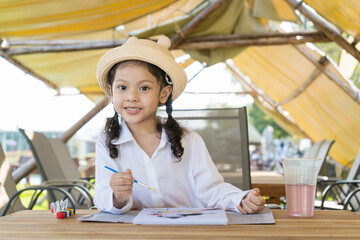 Asian girls are doing activities by drawing and painting.