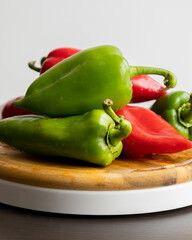Fresh Green and Red Bell Peppers on Rustic Wooden Cutting Board