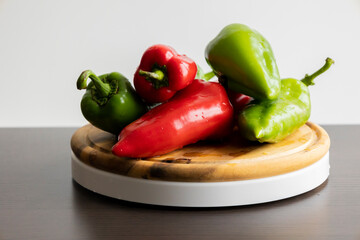 Fresh Green and Red Bell Peppers on Rustic Wooden Cutting Board