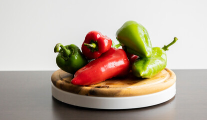 Fresh Green and Red Bell Peppers on Rustic Wooden Cutting Board