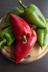 Fresh Green and Red Bell Peppers on Rustic Wooden Cutting Board