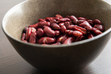 Red Beans in Dark Bowl on Moody Black Background Close-Up