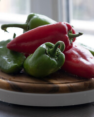 Fresh Green and Red Bell Peppers on Rustic Wooden Cutting Board
