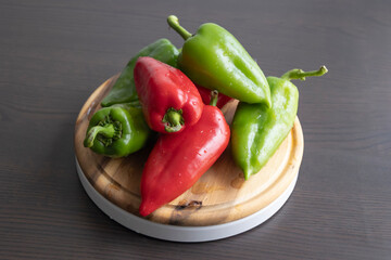Fresh Green and Red Bell Peppers on Rustic Wooden Cutting Board