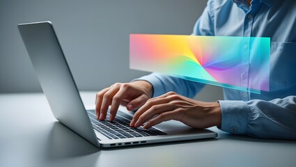 Man typing on laptop with colorful screen overlay for creative digital work space