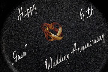 Minimal Gold Wedding Rings &ndash; Iron Wedding Anniversary. Clean and symbolic composition of gold wedding rings with dark tones and shallow depth of field, expressing strength and lasting comm