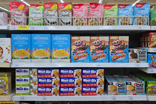 Penang, Malaysia &ndash; Sep 11, 2025: Supermarket shelf filled with various breakfast cereals and granola brands including Nacional, Sant&eacute;, Weet-Bix, and Tasti Oat Baked Squares.