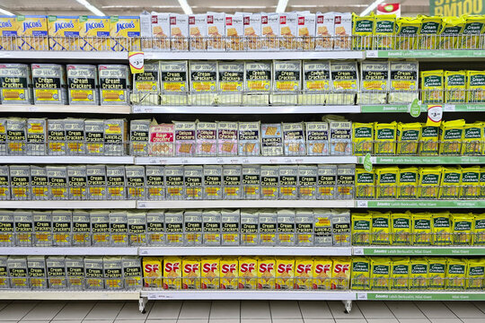 Penang, Malaysia &ndash; Sep 11, 2025: Shelves filled with Hup Seng cream crackers, Jacob&rsquo;s biscuits, and SP snacks displayed neatly in Giant Grocer supermarket, showcasing popular Malaysian brands.