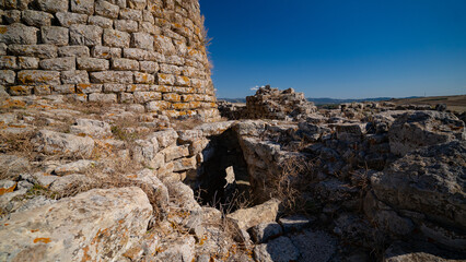Nuraghe Piscu megalithic stone tower ruins in Suelli, Sardinia, under clear blue sky