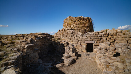 Nuraghe Piscu megalithic stone tower ruins in Suelli, Sardinia, under clear blue sky