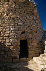 Nuraghe Piscu megalithic stone tower ruins in Suelli, Sardinia, under clear blue sky