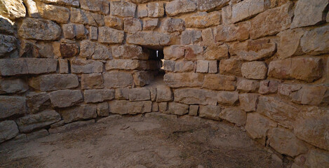Nuraghe Piscu megalithic stone tower ruins in Suelli, Sardinia, under clear blue sky