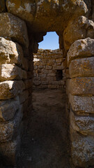 Nuraghe Piscu megalithic stone tower ruins in Suelli, Sardinia, under clear blue sky