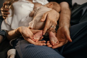 Family holding baby feet in hands