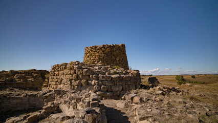Nuraghe Piscu megalithic stone tower ruins in Suelli, Sardinia, under clear blue sky