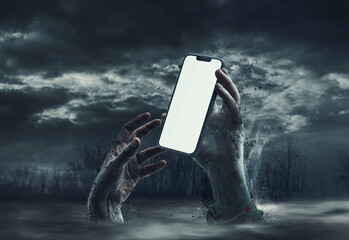 Zombie hands and smartphone with blank screen