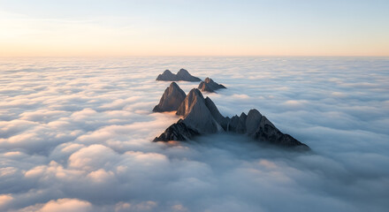 Majestic mountain peaks rising above lush clouds at sunrise aerial view nature photography serene atmosphere
