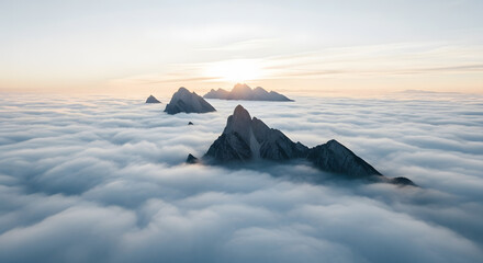 Sunrise over mountain peaks amidst clouds aerial view serene landscape nature photography