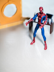 Naklejka premium Spider Man figure in his office with desktop and Computer.