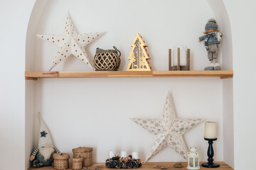 Shelf decorated for the holidays with stars wood figures and festive elements in cozy setting