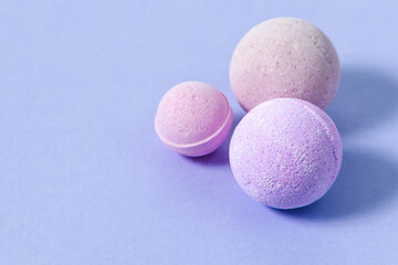 Colorful bath bombs arranged on a pastel surface in soft hues for relaxation and self care enjoyment