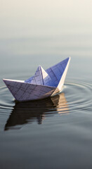 Obraz premium A single paper boat gently floats on calm water, creating subtle ripples and reflections.