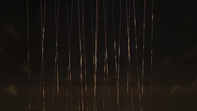 White glowing threads stretching from top to bottom on a black background.
