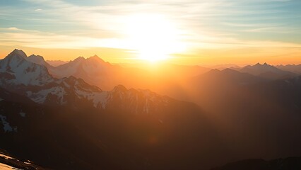 Fototapeta premium Snowy mountain peaks bathed in golden sunset light, capturing alpine beauty.