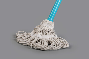 Mop with plastic handle isolated on gray