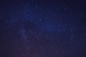 Obraz premium Breathtaking starry night sky filled with countless twinkling stars against deep blue backdrop, evoking sense of wonder and tranquility