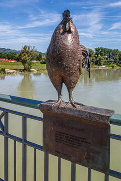 The Rooster, bronze sculpture on the Inn Bridge, made by Christine Perseis and installed in 2022. Symbol of peaceful coexistence between Germany and Austria, Simbach am Inn, Germany