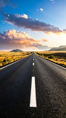 Empty road stretching to horizon at sunset