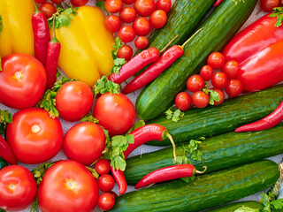 Top view of assorted fresh vegetables including tomatoes, cucumbers, chili peppers, and bell peppers, perfect for recipes and meal prep.