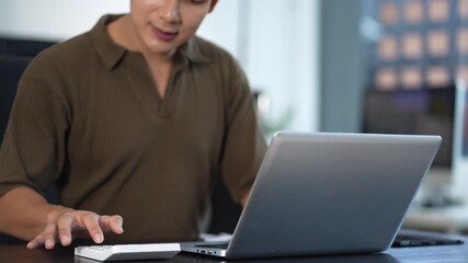 Businessman or accountant working on laptop computer with business document, graph diagram and calculator on office table in office. - Powered by Adobe