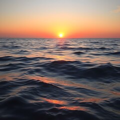 Fototapeta premium The sun sets over a calm ocean, casting a warm orange glow on the water's surface with gentle waves.