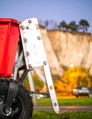 Red utility cart with a metal flap