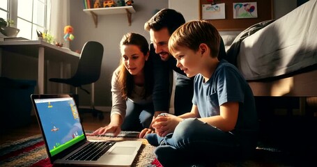 Happy family together enjoying time watching a game on laptop in bedroom at home
