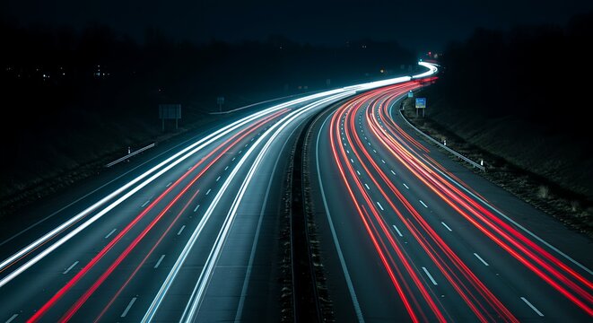 Nighttime highway traffic light trails over asphalt road cityscape