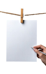 Blank sheet of paper hanging on a clothesline with a pen and hand