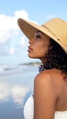 Woman wearing a wide-brimmed hat, gazing at the ocean