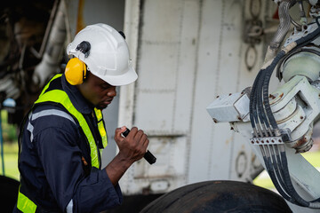 Aircraft maintenance engineer inspecting airplane engine with safety equipment and tools, aviation mechanic ensuring aircraft repair, safety check, and technical engineering service.