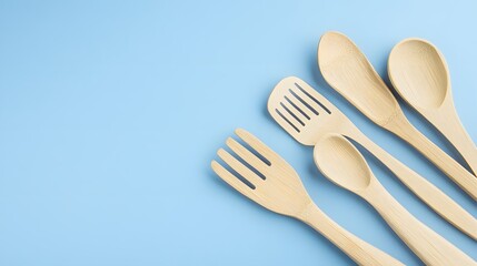 Wooden Kitchen Utensils on Blue Background Flat Lay