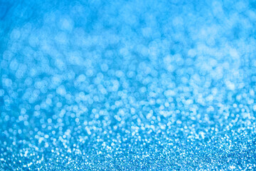 Abstract blue glitter bokeh backdrop with soft lights and frost-like sparkles, perfect for Christmas and New Year designs, winter greeting cards and banners. Photo