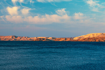 Landscape with blue Adriatic Sea and dunes in the evening.