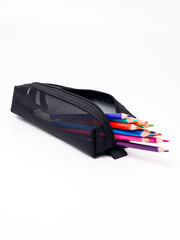 Colored pencils in a black pencil case on a white background