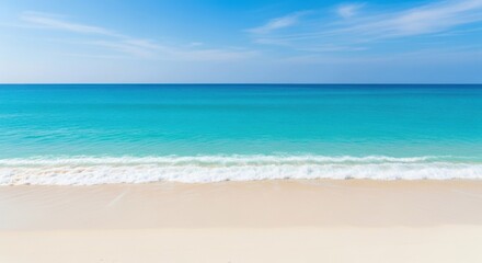 Obraz premium Serene beach scene with turquoise ocean and gentle waves under a blue sky