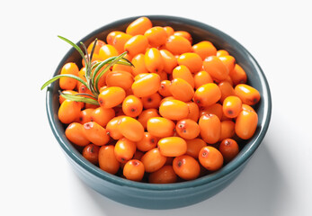 Ripe sea buckthorn berries and leaves in bowl on white background, closeup