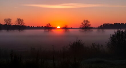 Obraz premium Sunrise over misty landscape