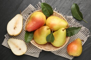 Many fresh pears and leaves on black table, flat lay